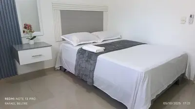 a white bed with two pillows on top of it at Remanso de Paz in Pedernales