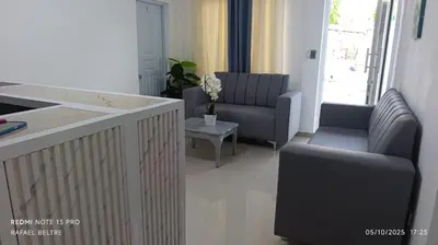 a living room with two chairs and a table at Remanso de Paz in Pedernales