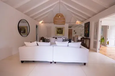 a large white living room with a white couch at Modern villa with private pool 1 km from the beach samana in El Limón