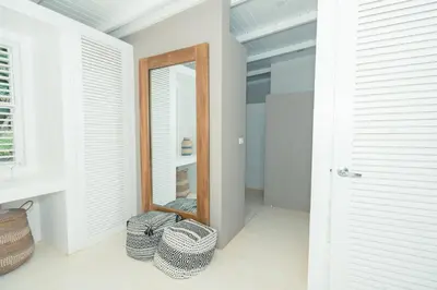 a mirror in a room with two wicker baskets at Modern villa with private pool 1 km from the beach samana in El Limón
