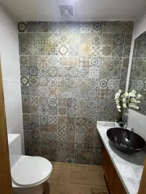 a bathroom with a toilet and a sink at Villa Enma RD in Nizao