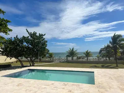 a swimming pool with a view of the ocean at Villa Enma RD in Nizao