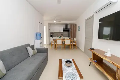a living room with a couch and a table at Modern 2BR Condo with Pool 10min walk to Beach - Caribbean Rose in San Rafael del Yuma