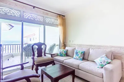 a living room with a couch and a table at Ocean front, direct access to the beach in Cabarete