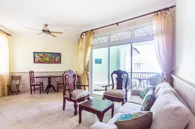 a living room with a couch and chairs and a table at Ocean front, direct access to the beach in Cabarete