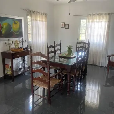 a dining room table and chairs in a room at Villa Rancho losindios