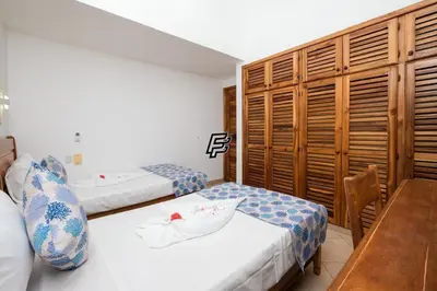 a hotel room with two beds and a table at Luxury Penthouse in front of the Sea in Las Terrenas in Las Terrenas