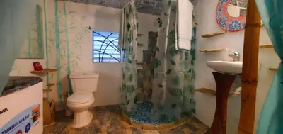 a bathroom with a toilet and a sink at Studio surrounded by nature in Cabarete