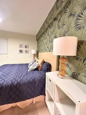 a bedroom with a blue bed and a plant wall at Your oceanfront paradise in La Puntica de Juan Dolio
