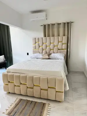 a bedroom with a large bed with a large headboard at Nashaly suite in Arroyo El Cabo