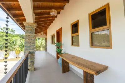a wooden bench in the hallway of a house at La Vega Villa with Private Pool and BBQ in Concepción de La Vega