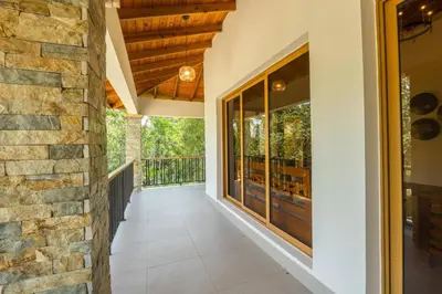 an internal walkway leading to a balcony with glass doors at La Vega Villa with Private Pool and BBQ in Concepción de La Vega