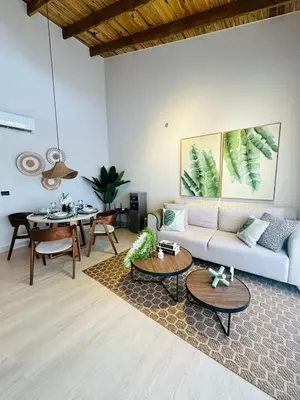 a living room with a couch and a table at IBE 402 Penthouse with Pool Garden Breeze Dominicus in La Laguna