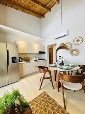 a kitchen and living room with a table and chairs at IBE 402 Penthouse with Pool Garden Breeze Dominicus in La Laguna