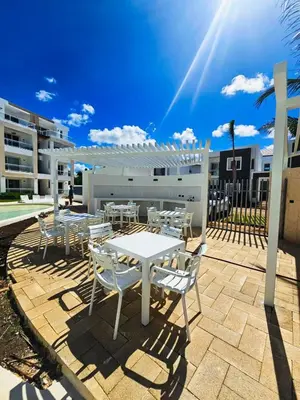 a white table and chairs on a patio at IBE 402 Penthouse with Pool Garden Breeze Dominicus in La Laguna