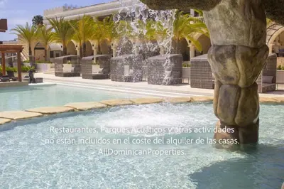 a fountain in the middle of a swimming pool at Sosua Ocean Village, Villas 24 in Sosúa