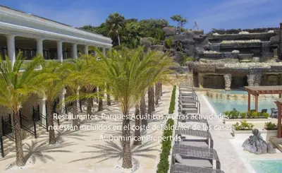 a resort with palm trees and a swimming pool at Sosua Ocean Village, Villas 24 in Sosúa