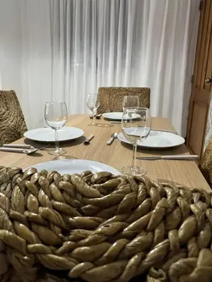 a table with wine glasses and a plate of food at Burungos Place at Terrazas del Caribe in Ensanche Savica de Mendoza