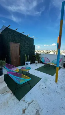 a group of colorful chairs and tables on a patio at Estancia Rincon del AMOR in Juan López
