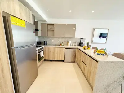 a kitchen with a stainless steel refrigerator and wooden cabinets at Garden Suite Vista Golf E-105 in Colorado