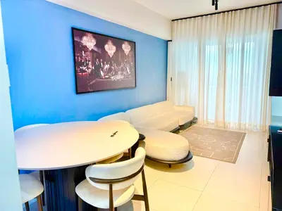 a living room with a white table and chairs at Ocean Views Escape at DGM Resort in Boca Chica