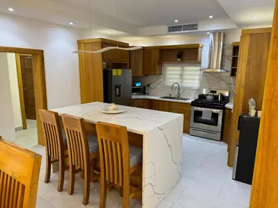 a kitchen with a table with chairs and a refrigerator at New villa with 4 bedrooms and 5 beds in La Romana