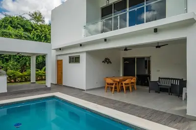 a villa with a swimming pool and a house at New villa with 4 bedrooms and 5 beds in La Romana