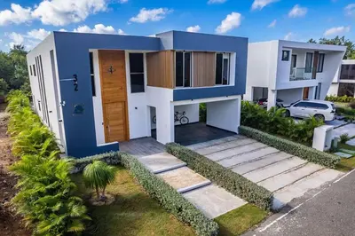 a house with a blue and white at Great villa with pool table in La Romana