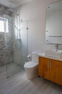 a bathroom with a shower and a toilet and a sink at Great villa with pool table in La Romana