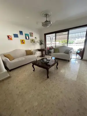 a living room with two couches and a coffee table at Cozy apartment in Piantini city center in Santo Domingo
