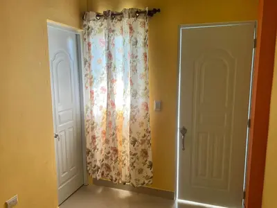 a room with a curtain and a door at hotel las yayas la vega in Concepción de La Vega