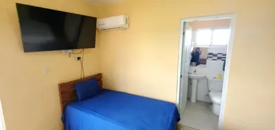 a room with a bed and a tv on the wall at hotel las yayas la vega in Concepción de La Vega
