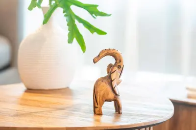 a wooden toy elephant on a table next to a vase at Hydra 103 Poolview Luxury Apt Dominicus in La Laguna