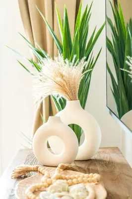 two white vases on a wooden table with a plant at Hydra 103 Poolview Luxury Apt Dominicus in La Laguna