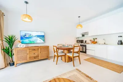 a kitchen and dining room with a table and chairs at Hydra 103 Poolview Luxury Apt Dominicus in La Laguna