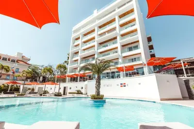a swimming pool in front of a large building at Boca Beach Residence 304 in Boca Chica