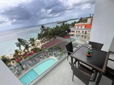a balcony with a table and a view of the ocean at Boca Beach 504, Boca Chica in Boca Chica