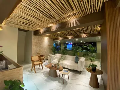 a living room with a white couch and tables at Residential Boca del Mar Tower III Apart 802 in Boca Chica