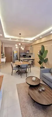 a living room with a couch and tables and a kitchen at Boca del Mar Tower III Apart 401 in Boca Chica