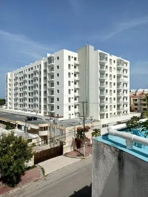 a large white apartment building with a swimming pool at Boca del Mar Tower III Apart 401 in Boca Chica