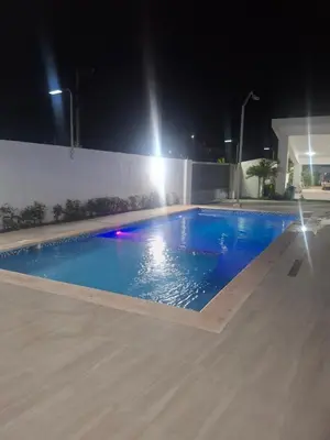a swimming pool at night with blue water at Luna airport retreat in Boca Chica