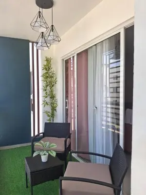 a living room with two chairs and a table at Luna airport retreat in Boca Chica