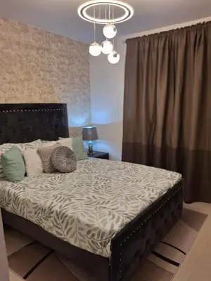 a bedroom with a large bed with a black headboard at Luna airport retreat in Boca Chica