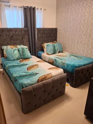two beds sitting next to each other in a room at Luna airport retreat in Boca Chica