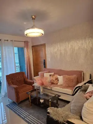 a living room with a couch and a table at Luna airport retreat in Boca Chica