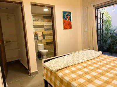 a bedroom with a bed and a bathroom with a toilet at Colonial leyton apartment in Santo Domingo