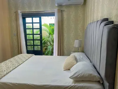 a bedroom with a large bed and a window at Colonial leyton apartment in Santo Domingo