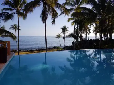 a swimming pool with a view of the ocean at Villa Los Gorgones in Las Galeras