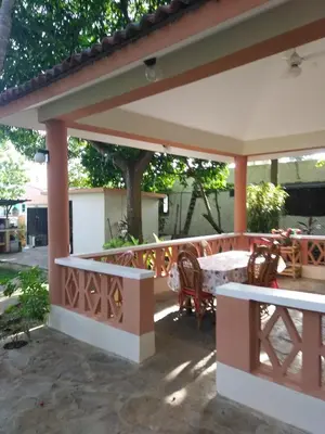 a pavilion with a table and chairs on a patio at Residencial Estephany in Sosúa