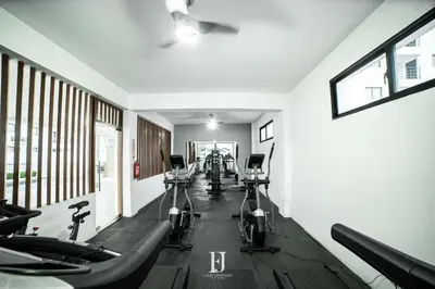 a gym with a row of exercise bikes in a room at Fj Luxury Apartment in Santiago de los Caballeros